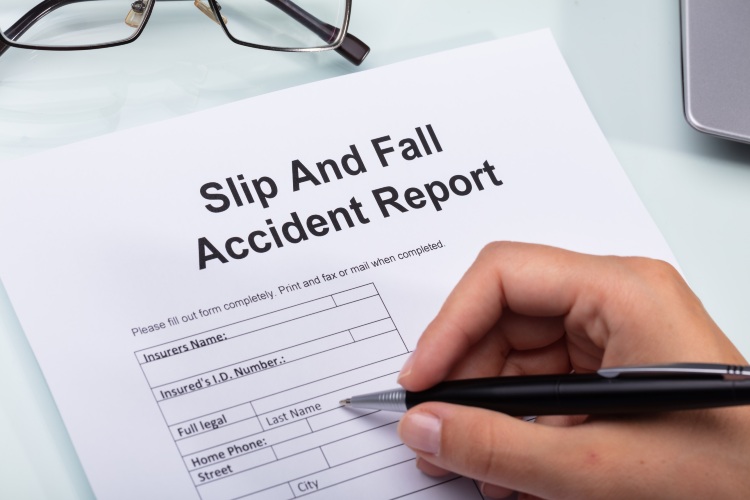 Woman Filling Out Slip and Fall Accident Report